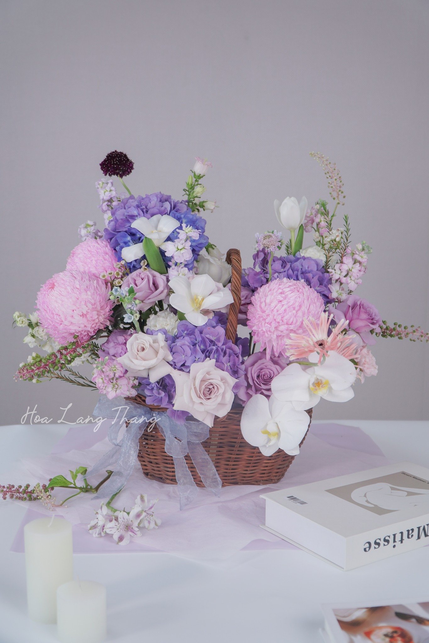 Giỏ hoa tươi với tulip, lan hồ điệp, và cúc, kiểu cắm trang nhã, sắc màu pastel