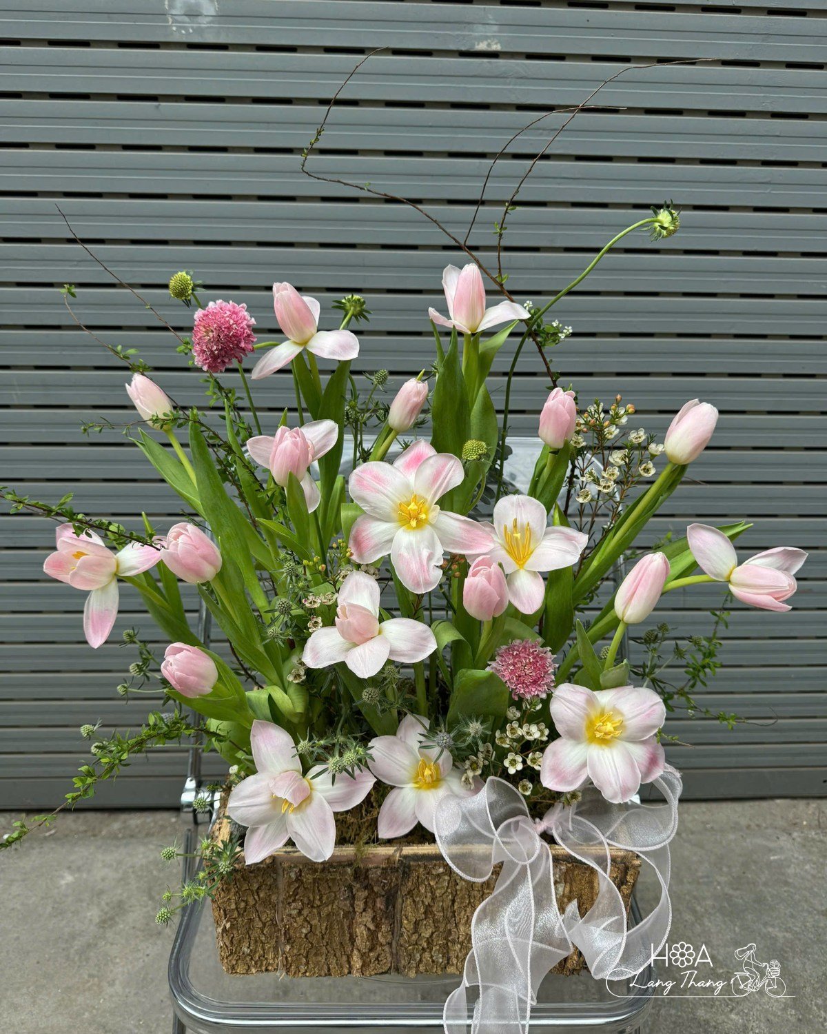Bình hoa cắm tay đầy tulip hồng và hoa cỏ trang trí nhẹ nhàng